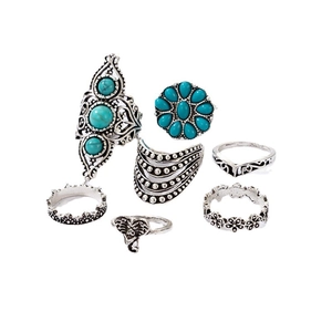 Bohemian silver ring set featuring turquoise stones and elephant carving on white background