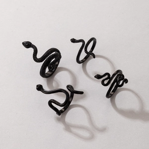 Detail of four-piece punk style black snake rings set with textured and smooth finishes