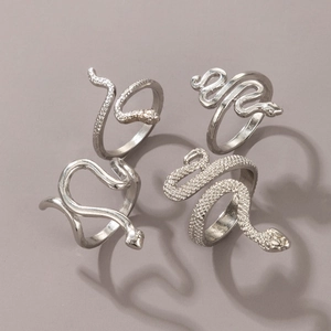 Detail view of silver snake ring set with textured scale patterns and polished finish