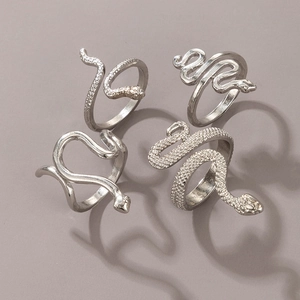 Detail of four-piece silver snake ring set featuring textured and polished finishes