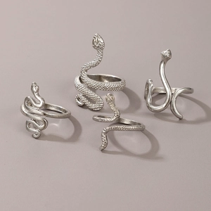Detail of four-piece silver snake ring set featuring intricate scale texture and animal design