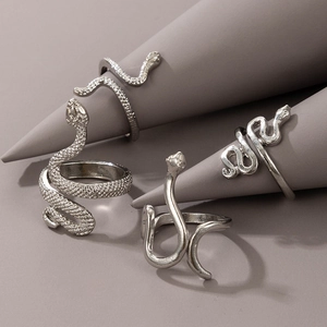 Macro shot of 4-piece vintage snake ring set with detailed scales on grey display