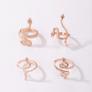 Detailed view of four rose gold snake rings with scale textures and smooth finishes