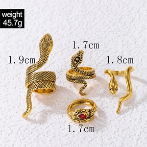 Detail view of four vintage snake rings in gold finish with weight and size measurements