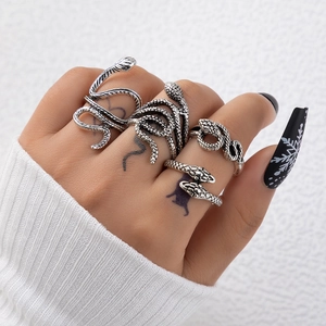 Close-up of vintage silver snake ring set with detailed scales and wrap-around textures