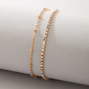 Detail of gold-tone tennis anklet set with AB crystal rhinestones and bead chain