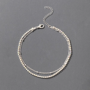 Detail of double-layer silver anklet with AB rhinestones and delicate bead chain