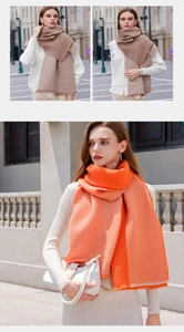 Detailed texture of dual-sided pleated cashmere-like scarf in camel and bright orange