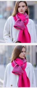 Detail of two-tone knit scarf with vertical ribbed texture in magenta and dark grey colors