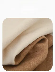 Close-up of soft warm fleece fabric texture in beige and light brown for winter scarves