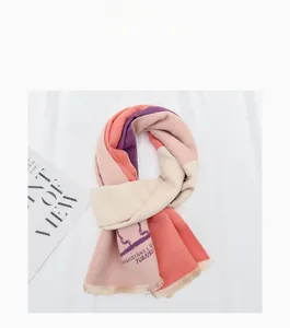 Close-up of multicolor knit children scarf with fringe detail and printed pattern