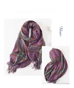 Close-up of cashmere-like scarf with thick purple, brown, and blue plaid texture and tassels
