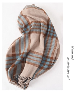 Detailed view of beige plaid scarf with soft tassels and premium woven texture