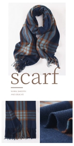 Macro view of blue plaid cashmere-like scarf showing soft texture and tassel detail