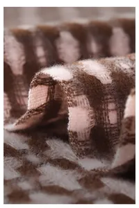 Macro shot of pink and brown plaid scarf showing soft skin-friendly fabric texture
