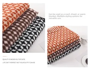 Close-up of tricolor plaid scarves with cross-weave texture and tassel fringe detailing