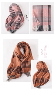 Detailed macro view of pink and orange plaid scarves with classic long tassels texture
