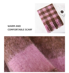Detail of soft plush plaid scarf in pink and brown with long decorative tassels