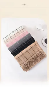 Detail of soft plaid scarves in various colors with fringe edges for winter warmth