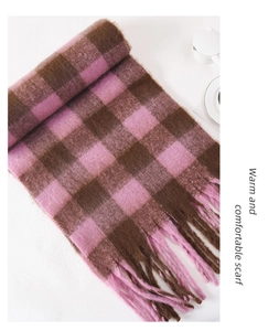 Detail of pink and brown checkered plush scarf with soft fringe and thick texture