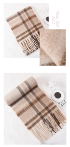 Detail of plush beige plaid scarf featuring soft fiber texture and elegant long fringe trim
