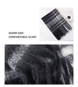 Macro detail of thick black and grey plaid scarf texture with long fringe tassels