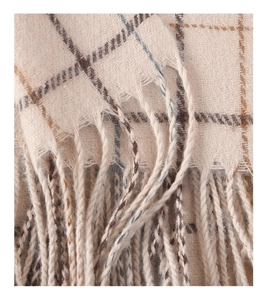Macro detail of high-quality beige plaid scarf texture with woven fringe tassels