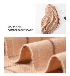 Macro view showing the soft cashmere-like texture and classic plaid pattern of the scarf