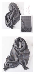 Detailed views of grey plaid cashmere scarf with orange accents and tassel fringe details