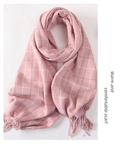 Close-up of pink plaid scarf with soft cashmere-like texture and tassel detail