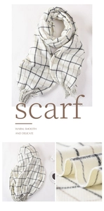 Detail showing the thick plaid texture and soft tassel fringe of the cashmere scarf