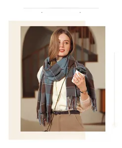 Close-up of color-block plaid scarf with long fringes in brown and grey tones