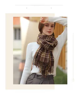Detail of soft cashmere feel scarf with brown check pattern and fringe trim finish
