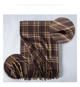Macro shot of brown plaid faux cashmere scarf showing fabric texture and tassel details