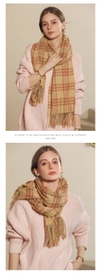 Detailed view of khaki plaid cashmere-like scarf with fringe tassels for autumn
