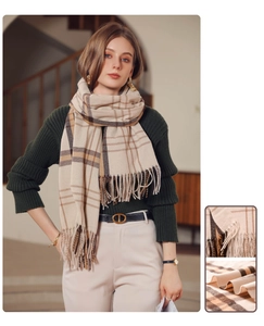 Detailed view of the plaid tassel scarf featuring beige and brown cashmere texture