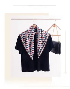 Detail of multi-color diamond lattice print scarf styled with a black t-shirt
