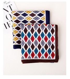 Close-up of retro diamond-check knitted scarves in navy and brown trim color options