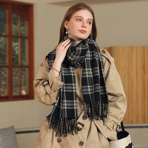 Elegant black and white plaid cashmere scarf with fringes styled with a khaki trench coat