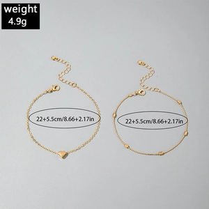 Detail of gold layered anklets with heart charm and beads showing 22+5.5cm size info