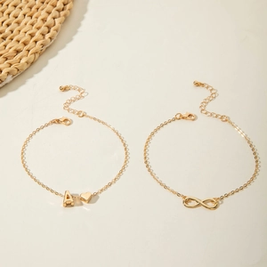 Close-up of gold-plated infinity and letter A heart charm bracelets with lobster clasp