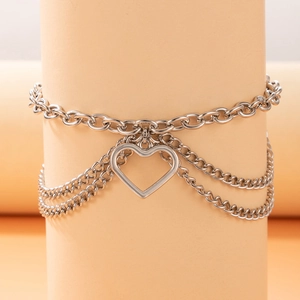 Detailed view of silver layered anklet featuring oval link chain and hollow heart pendant