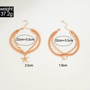 Detail of gold layered anklets featuring starfish and hollow heart charms with length specs