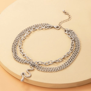 Three-layer silver ankle chain featuring a detailed snake pendant and adjustable lobster clasp