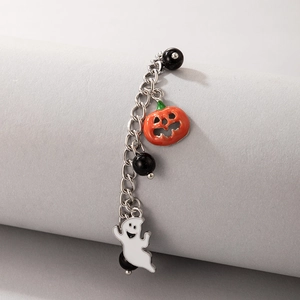 Detail of Halloween anklet with orange pumpkin charm, white ghost, and black beads