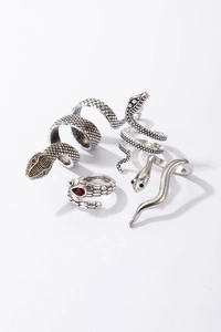 Detailed view of gothic snake rings with scales, green gems and vintage silver finish