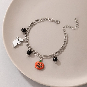 Detail of Halloween charm bracelet with orange pumpkin, white ghost, and black beads