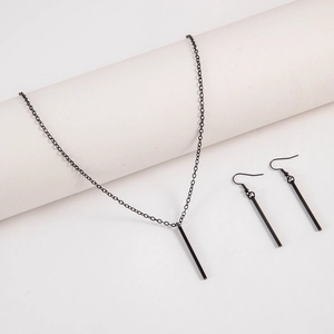 Detail of minimalist matte black long bar pendant necklace and matching drop earrings set
