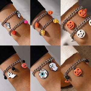 Halloween charm bracelets set with pumpkin, ghost, and skull pendants for festive jewelry