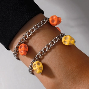 Halloween chain bracelet with colorful skull beads and festive pumpkin charms on wrist